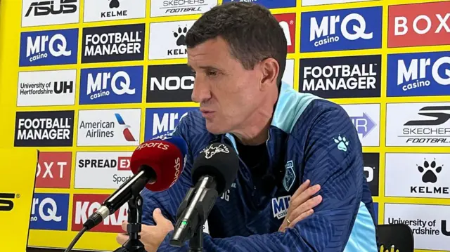 Javi Gracia speaking into two microphones during a press conference