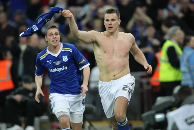 Ben Turner celebrates with his shirt off 