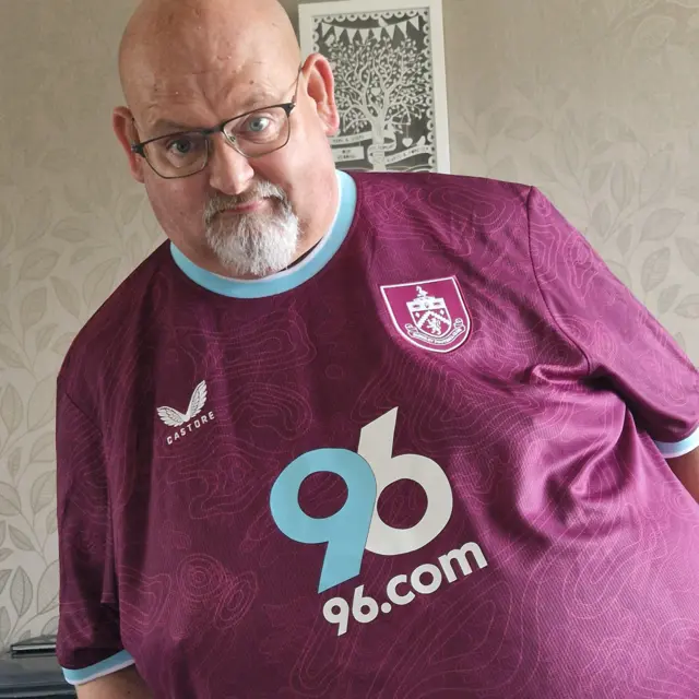 A Burnley fan in a Clarets home kit