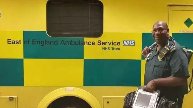 Glenn Carrington carrying equipment to an ambulance