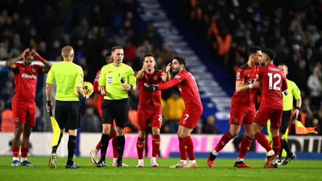 Wolves players argue with the referee