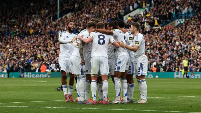 Leeds players huddle to celebrate