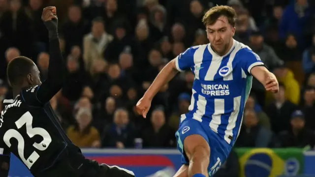 Jack Hinshelwood of Brighton, running to score a goal in a blue and white stripe kit. 