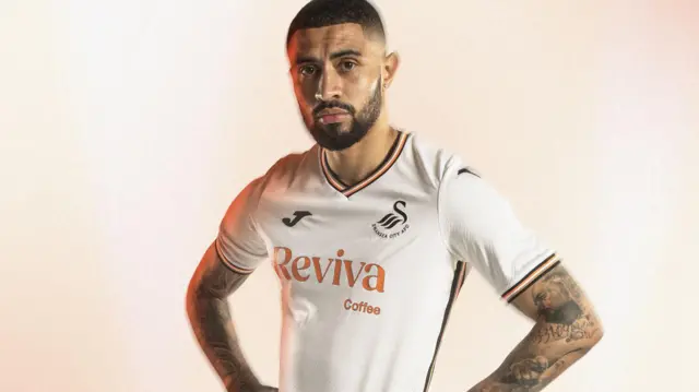 Midfielder Josh Ginnelly shows off the new Swansea City home shirt