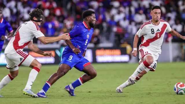 Haiti's Duckens Nazon (centre) in action against Peru