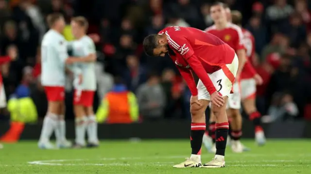 Noussair Mazraoui of Manchester United looks dejected at full time