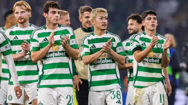 Celtic players applaud the fans