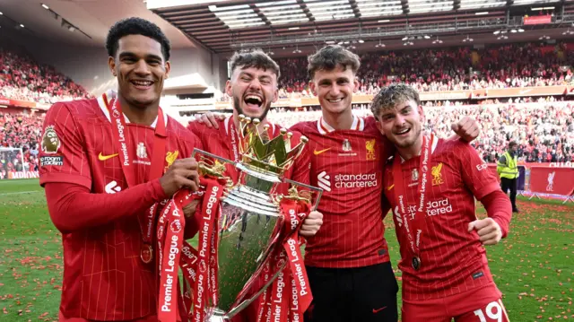 Jarell Quansah, Connor Bradley, Tyler Morton and Harvey Elliott with the Premier League trophy