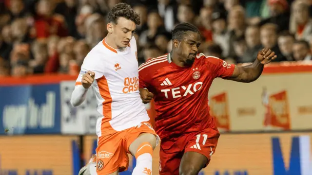 Dundee United's Miller Thomson and Aberdeen's Luis Lopes