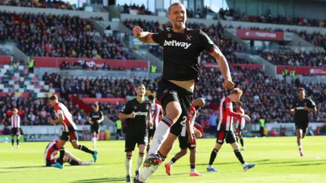 Tomas Soucek jumps in the air to celebrate