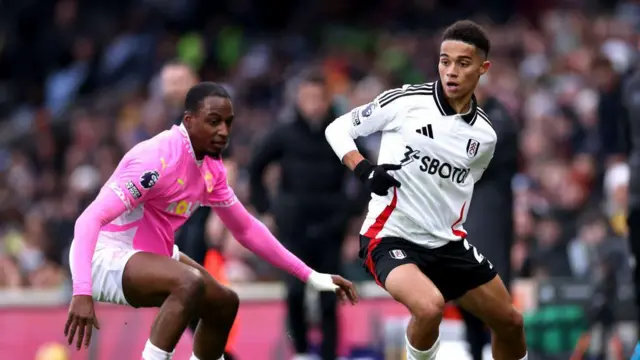 Joshua King of Fulham controls the ball whilst under pressure from Joe Aribo of Southampton during the Premier League match between Fulham FC and Southampton FC at Craven Cottage