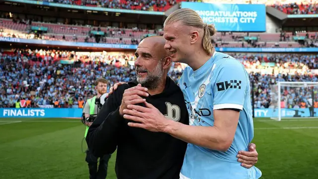 Pep Guardiola celebrates with Erling Haaland