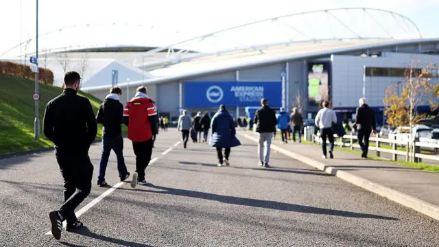 Supporters arrive outside the Amex Stadium