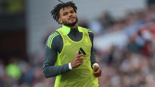 Tyrone Mings warms up as a substitute