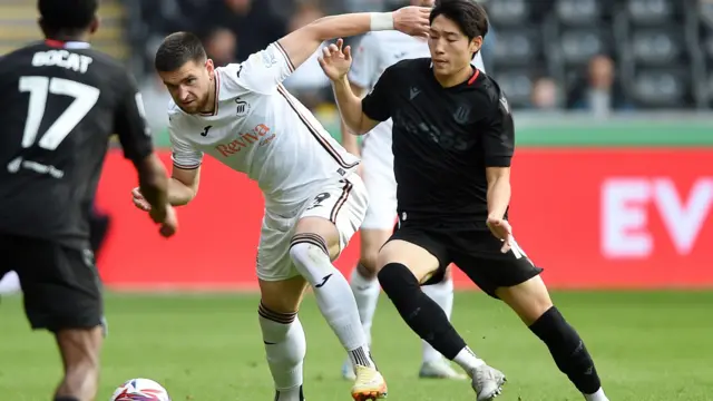 Zan Vipotnik challenges Bae Jun-Ho during Swansea's draw with Stoke earlier this season