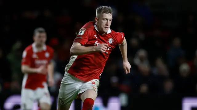 Ross McCrorie running on the pitch with the ball at his feet during a game for Bristol City