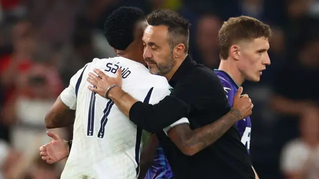  Savio of Tottenham Hotspur is embraced by Roberto de Zerbi