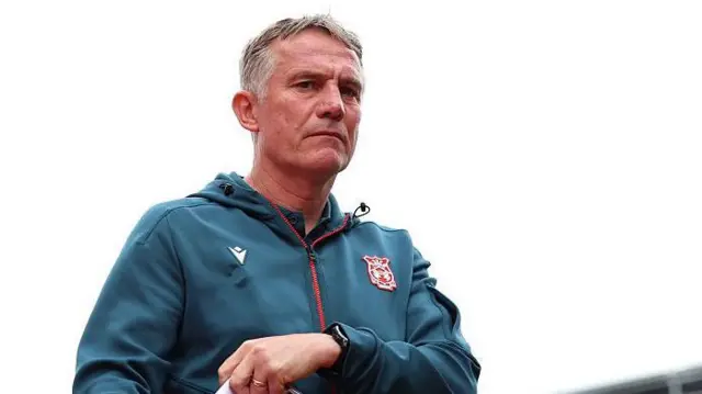 Phil Parkinson wearing turquoise zip up hoodie.