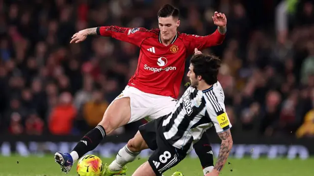 Benjamin Sesko is tackled by Sandro Tonali during Manchester United's game against Newcastle United at Old Trafford on 26 December 2025