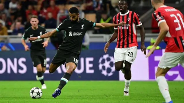 Cody Gakpo shooting the football in a match for Liverpool