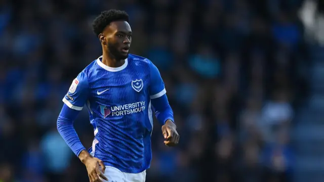 Abu Kamara playing for Portsmouth in their blue home kit in April 2024