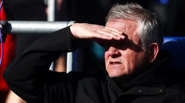 Chris Wilder shields his eyes from the sun