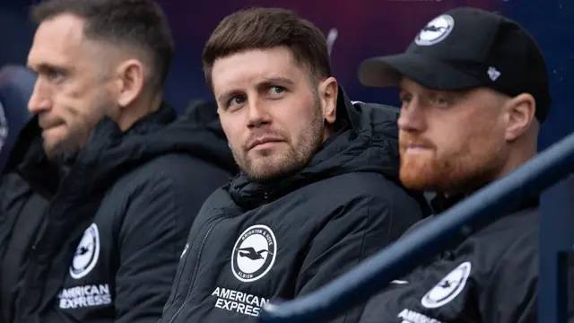 Brighton manager Fabian Hurzeler sat on the bench with his backroom staff