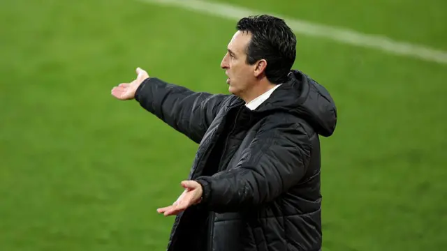 Unai Emery holds his arms outstretched on the touchline