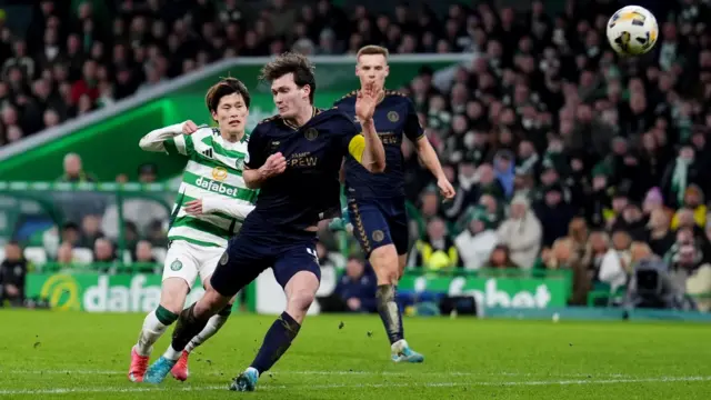 Kilmarnock defender Joe Wright tussles with Kyogo Furuhashi