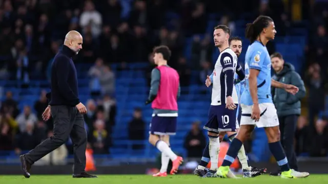 Pep Guardiola, manager of Manchester City, walks off at full time