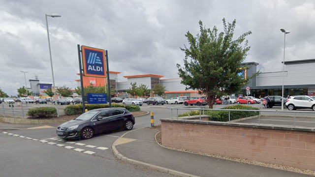 Google street view of the retail park - with an entrance to Aldi supermarket with a blue sign.