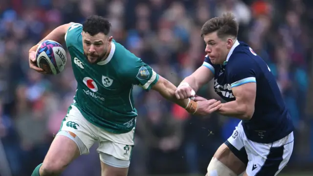 Huw Jones tries to tackle Ireland's Robbie Henshaw