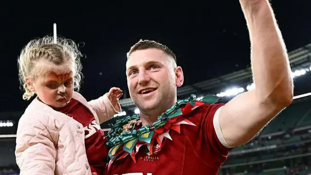 Finn Russell wearing a homemade garland