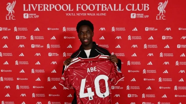 Josh Abe holding his Liverpool shirt with the number 40 on the back