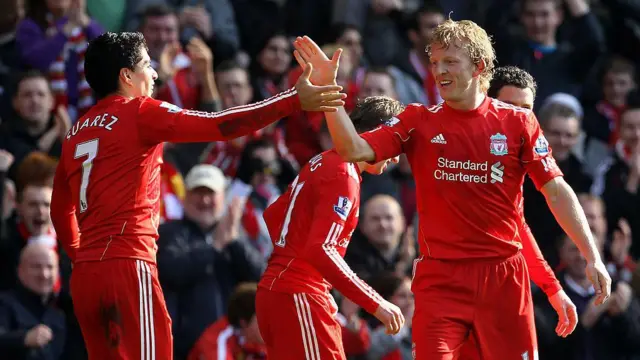 Dirk Kuyt of Liverpool celebrates scoring the opening goal with team mate Luis Suarez