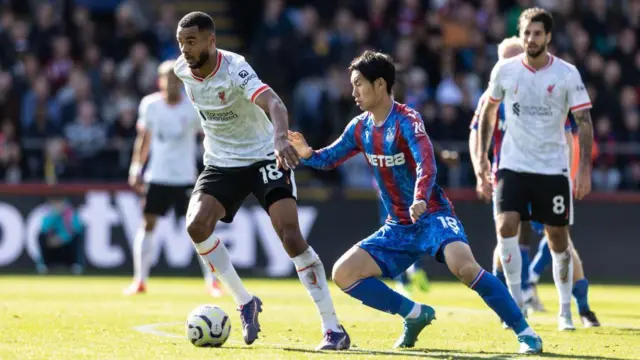 Liverpool's Cody Gakpo (left) breaks away from Crystal Palace's Daichi Kamada