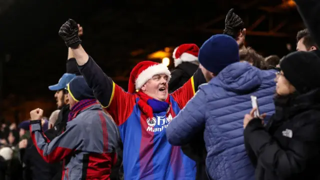 A Crystal Palace fan in a Santa hat 