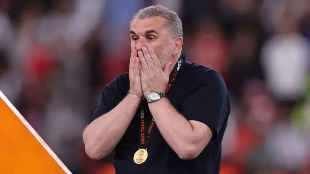Ange Postecoglou reacts after receiving Europa League medal