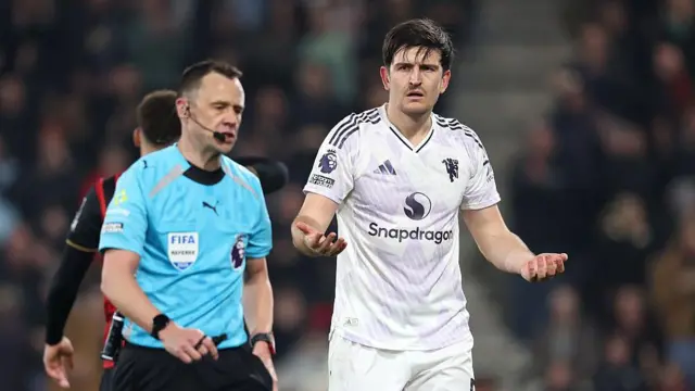 Harry Maguire gestures after receiving a red card