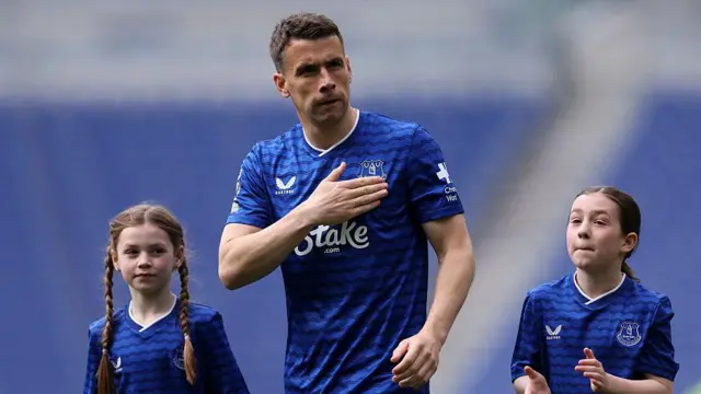 Seamus Coleman of Everton acknowlegdes the fans with his family