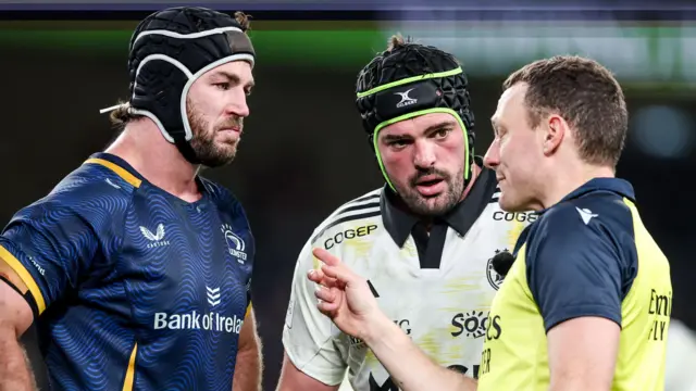 Caelan Doris and Gregory Alldritt speak to a referee