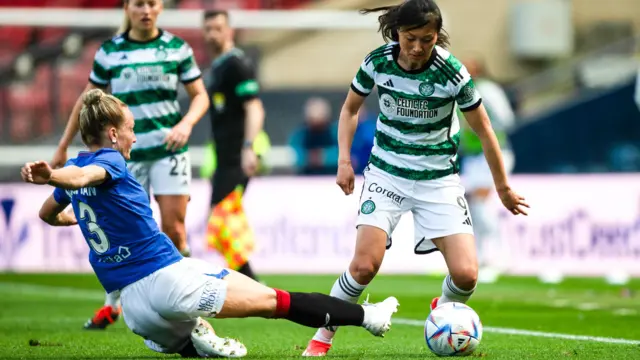 Rangers' Rachel McLauchlan slides in to tackle Celtic's Shen Mengyu