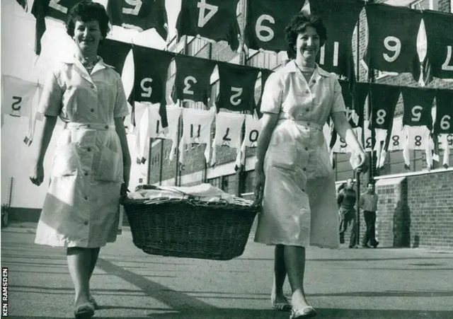 Manchester United's laundry ladies hanging up the kit outside Old Trafford