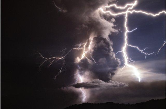 Lightning strikes as a column of ash surrounds the crater of Taal Volcano