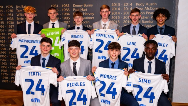 Image of Leeds United's news scholars holding up their shirts