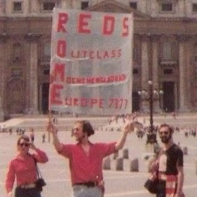 An image of someone in the 1970s holding a Reds banner in Rome