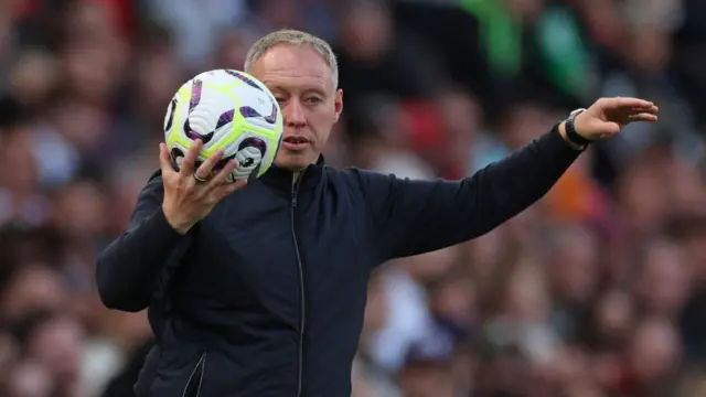 Leicester City's Welsh Manager Steve Cooper returns the ball during the English Premier League football match between Arsenal and Leicester City at the Emirates Stadium