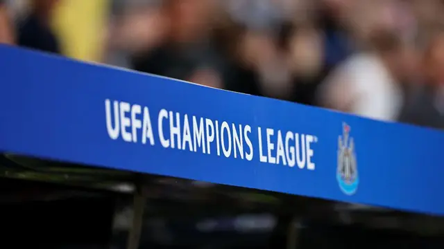 Champions League branding next to a Newcastle United emblem