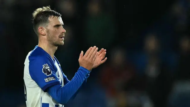 Pascal Gross applauds the Brighton fans