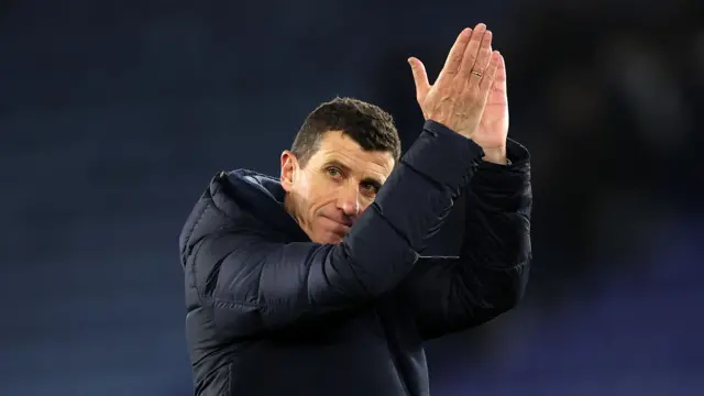 Javi Gracia applauding fans wearing a navy blue puffer jacket